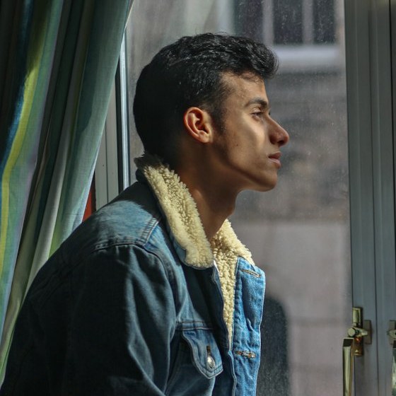 A man looking out a window.
